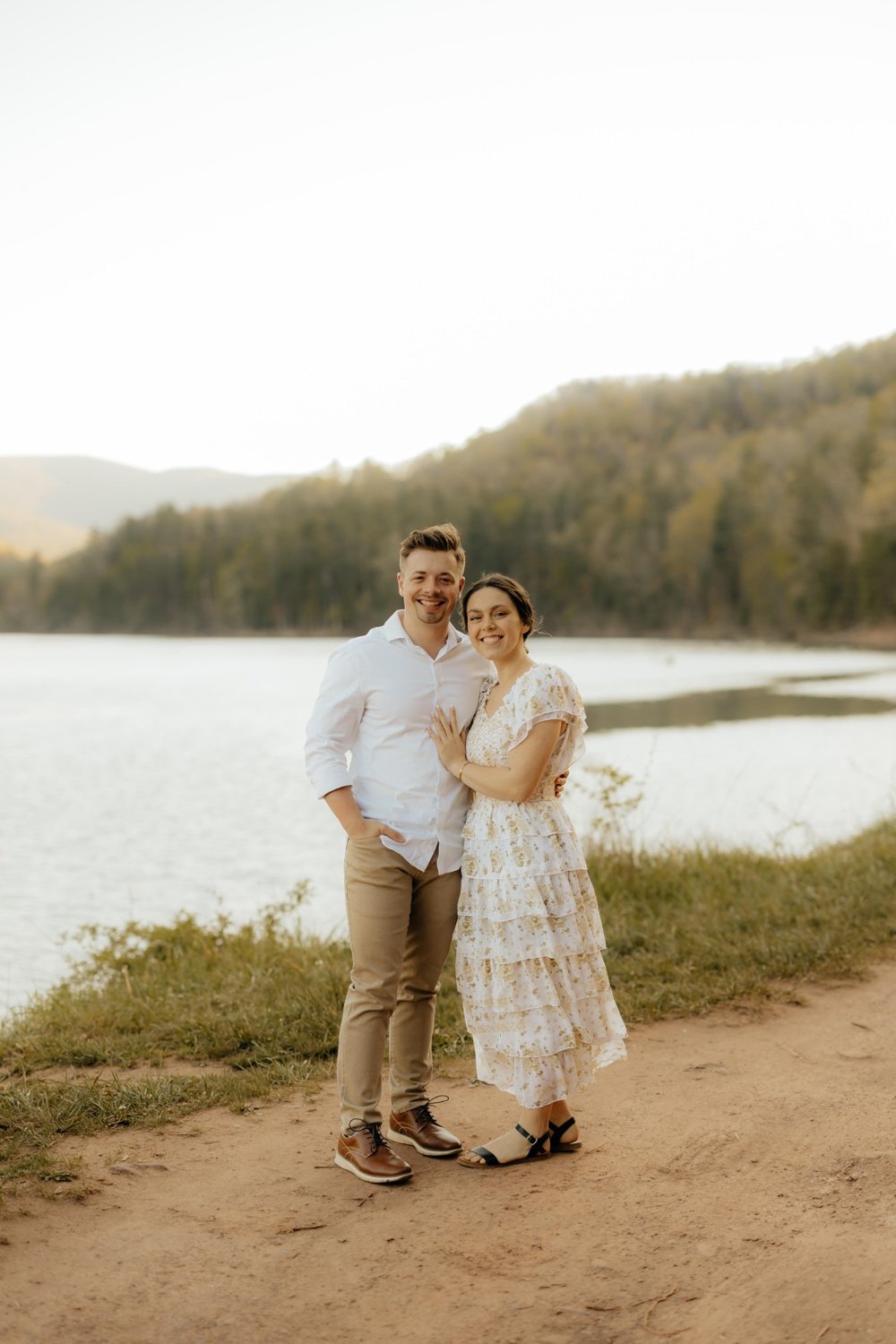 Jonathon and Emma Mullet, founders of By Design Supplements, standing by a lake